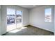 Sunny bedroom with a sliding glass door to the deck and a window with neighborhood views at 8509 Orchard City Dr, Littleton, CO 80125