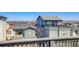 View of gray homes with rooftop patio, perfect for enjoying the suburban scenery at 8509 Orchard City Dr, Littleton, CO 80125
