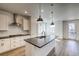 Bright kitchen with island, pendant lighting, stainless steel appliances, and a white subway tile backsplash at 8509 Orchard City Dr, Littleton, CO 80125