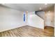Cozy living room with modern wood flooring and recessed lighting near the staircase at 8509 Orchard City Dr, Littleton, CO 80125