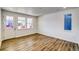 Inviting living room with wood floors, plenty of natural light and white door to the outside at 8509 Orchard City Dr, Littleton, CO 80125