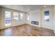 Modern living room with wood floors, an electric fireplace, and large windows for ample natural light at 8509 Orchard City Dr, Littleton, CO 80125