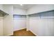 Walk-in closet with built-in shelving and carpet floors at 8509 Orchard City Dr, Littleton, CO 80125