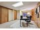 A finished basement office with paneled walls, and a comfortable chair at 7288 S Zephyr Way, Littleton, CO 80128