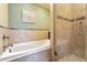 Bathroom features a tiled bathtub, tiled shower, and hardware at 7288 S Zephyr Way, Littleton, CO 80128