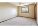 Empty bedroom features a window, carpet and a ceiling fan at 7288 S Zephyr Way, Littleton, CO 80128