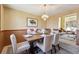 Warm dining room featuring a wooden table with seating for four, complemented by elegant decor and soft natural lighting at 7288 S Zephyr Way, Littleton, CO 80128