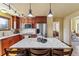 Modern kitchen featuring stainless steel appliances, granite countertops, and custom cabinetry with a functional island at 7288 S Zephyr Way, Littleton, CO 80128