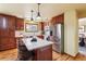 Well-lit kitchen boasting custom wood cabinets, stainless steel appliances, and granite countertops on an oversized center island at 7288 S Zephyr Way, Littleton, CO 80128