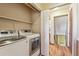 Laundry room with a washer and dryer, featuring shelving above at 7288 S Zephyr Way, Littleton, CO 80128