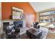 Cozy living room featuring a brick fireplace, mantel and artwork at 7288 S Zephyr Way, Littleton, CO 80128