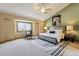 This main bedroom features an accent wall, windows and a ceiling fan at 7288 S Zephyr Way, Littleton, CO 80128