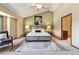 This main bedroom features an accent wall, windows, and a ceiling fan at 7288 S Zephyr Way, Littleton, CO 80128