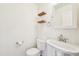 Bathroom with a white pedestal sink, toilet, and decorative wood shelves at 23505 E Platte Dr # 8D, Aurora, CO 80016