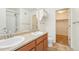 Bathroom featuring double sinks, wood cabinets, and shower with tub at 23505 E Platte Dr # 8D, Aurora, CO 80016