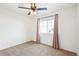 Carpeted bedroom featuring a ceiling fan with lighting and a window with curtains at 23505 E Platte Dr # 8D, Aurora, CO 80016