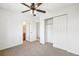 Bedroom featuring a ceiling fan, closet, and doorways leading to other rooms at 23505 E Platte Dr # 8D, Aurora, CO 80016