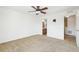 Open carpeted bedroom with ceiling fan, wall mounted tv and neutral colored walls at 23505 E Platte Dr # 8D, Aurora, CO 80016