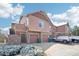 Townhome's exterior featuring attached garages and snow-dusted landscaping on a sunny day at 23505 E Platte Dr # 8D, Aurora, CO 80016