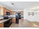 Well-lit kitchen featuring stainless steel appliances, wood cabinets, and tile flooring at 23505 E Platte Dr # 8D, Aurora, CO 80016