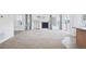 Spacious living room featuring plush carpeting, bright windows, and a cozy fireplace at 23505 E Platte Dr # 8D, Aurora, CO 80016