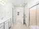 Bright bathroom with a modern vanity, tiled shower, and neutral color palette creates a clean and welcoming space at 8850 Sedalia St, Commerce City, CO 80022