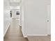 Bright hallway with hardwood floors leading to a sunlit living space at 8850 Sedalia St, Commerce City, CO 80022