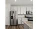 Bright kitchen features white cabinets, stainless steel appliances and granite countertops at 8850 Sedalia St, Commerce City, CO 80022