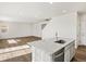Open floor plan features bright kitchen with island and view into the spacious living room at 8850 Sedalia St, Commerce City, CO 80022
