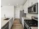 Bright kitchen features white cabinets, stainless steel appliances and granite countertops at 8850 Sedalia St, Commerce City, CO 80022