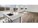 Kitchen island with stainless sink provides view to outdoor entertaining space at 8850 Sedalia St, Commerce City, CO 80022