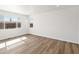 Sunlit living room with light wood floors and large windows at 8850 Sedalia St, Commerce City, CO 80022