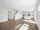 Open-concept living space with hardwood floors and a white kitchen at 8850 Sedalia St, Commerce City, CO 80022