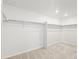 Bright walk-in closet, ready to organize your wardrobe, with clothing rods and neutral carpet at 8850 Sedalia St, Commerce City, CO 80022