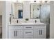 Bathroom featuring double sinks, stylish mirrors, modern fixtures, and a glass-enclosed shower at 2466 S Delaware St # 3, Denver, CO 80223