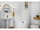 Chic powder room with pedestal sink, modern fixtures, and shiplap wall at 2466 S Delaware St # 3, Denver, CO 80223