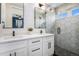 Contemporary bathroom with a double vanity, modern mirrors, and glass shower enclosure at 2466 S Delaware St # 3, Denver, CO 80223