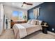 Cozy bedroom with a ceiling fan, a large window, and stylish decor at 2466 S Delaware St # 3, Denver, CO 80223