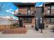 Modern townhouse exterior with brick facade, metal accents, and private balconies at 2466 S Delaware St # 3, Denver, CO 80223