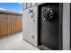 Contemporary front door with a wreath, modern sconce, and stylish exterior at 2466 S Delaware St # 3, Denver, CO 80223