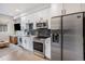 Well-equipped kitchen featuring white cabinetry, stainless steel appliances, and modern finishes at 2466 S Delaware St # 3, Denver, CO 80223