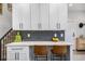 Bright kitchen bar with barstool seating, marble counters and subway tile backsplash at 2466 S Delaware St # 3, Denver, CO 80223