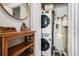 Laundry area featuring stacked washer and dryer units, plus additional shelving at 2466 S Delaware St # 3, Denver, CO 80223