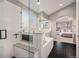 Bathroom featuring a large soaking tub, black tiled floor and glass shower at 4501 Whitehall Ln, Highlands Ranch, CO 80126