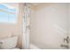 Bright bathroom showcasing tub with white tile surround and a window for natural light at 4501 Whitehall Ln, Highlands Ranch, CO 80126