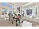 Sunlit dining room featuring a large window, high ceilings, neutral colored walls and stylish grey upholstered chairs at 4501 Whitehall Ln, Highlands Ranch, CO 80126