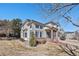 Charming two-story home with brick accents, landscaped yard, and inviting front porch at 4501 Whitehall Ln, Highlands Ranch, CO 80126