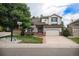 Charming two-story home with a well-manicured lawn, mature trees, and a two-car garage at 4501 Whitehall Ln, Highlands Ranch, CO 80126