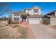 Charming two-story home with a well-maintained lawn and a brick pathway leading to the front door at 4501 Whitehall Ln, Highlands Ranch, CO 80126