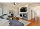 Cozy living room with a fireplace, hardwood floors, comfortable seating and an open layout to the rest of the home at 4501 Whitehall Ln, Highlands Ranch, CO 80126